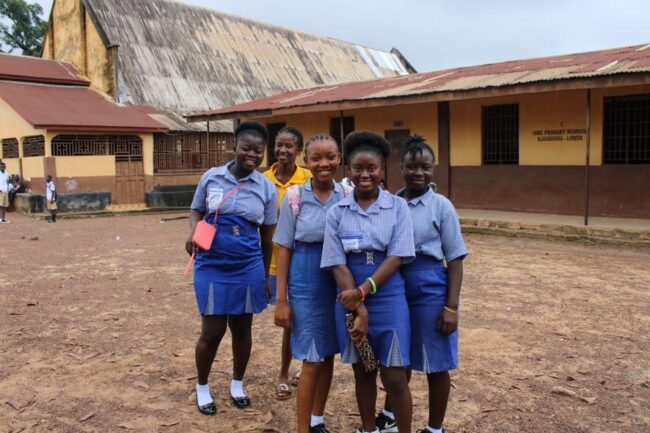 School girls standing in front of UMC school